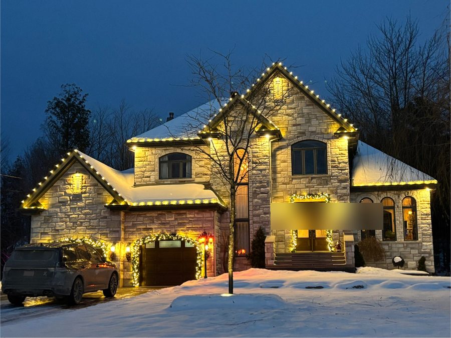 Roofline lighting with garland accents — LitUp Vancouver installation