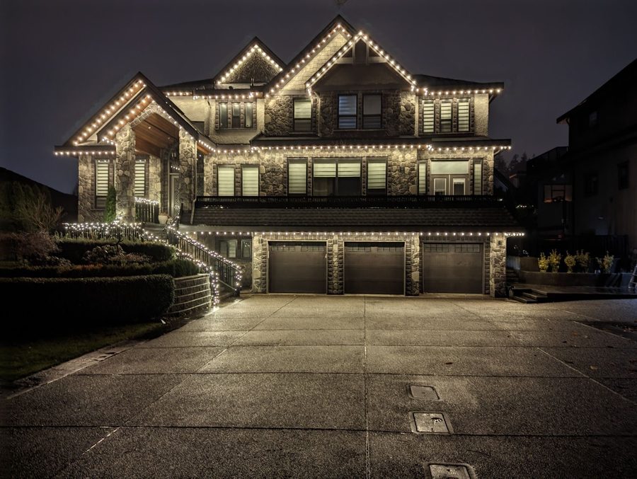 Full roofline installation, stone exterior — LitUp Vancouver installation